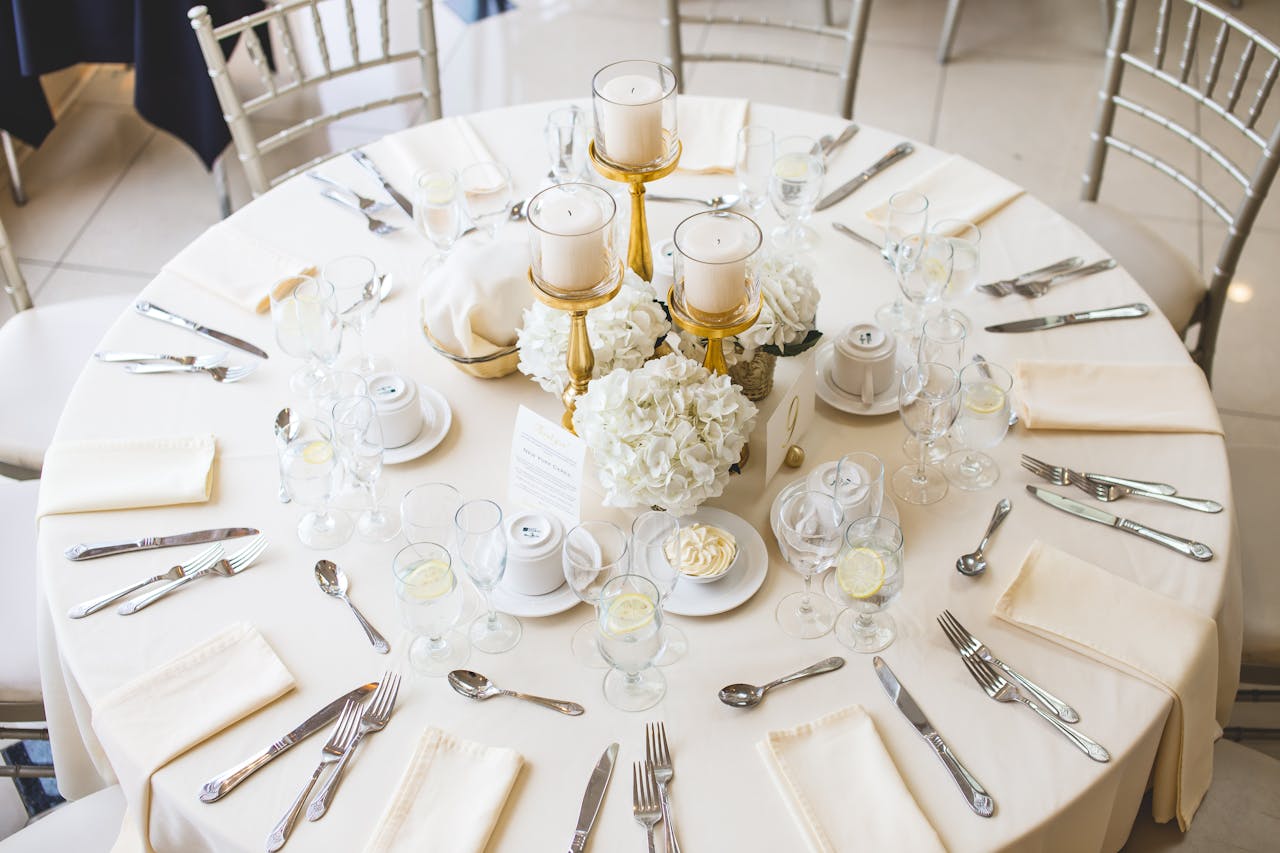 services-02 Beautifully arranged dining table setting with candles and floral centerpiece, perfect for a wedding reception.