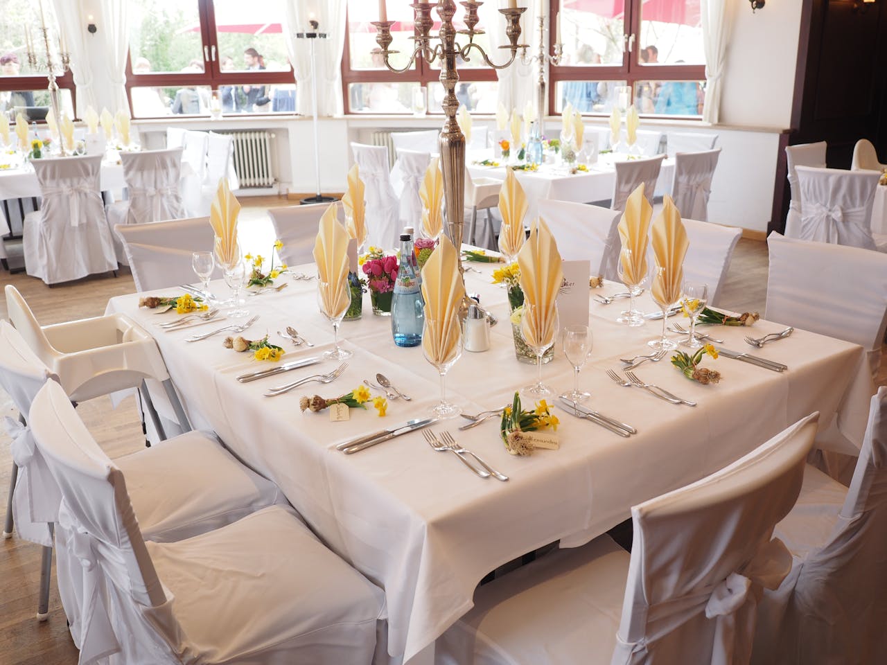 about-us A beautifully decorated dining room table set for an elegant celebration indoors.